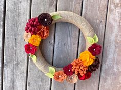 a wreath made out of burlocks and fabric flowers