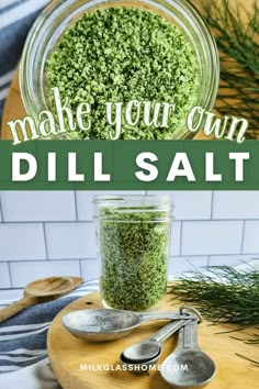 a jar filled with dill salt on top of a cutting board