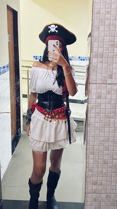 a woman dressed as a pirate taking a selfie