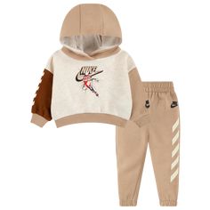 Swaddle up your little bundles of joy in the cozy charm of the Nike Fleece Hoodie Set. Supersoft and fuzzy on the inside, this oh-so-comfy set ensures top-to-bottom snugness—making it a perfect ensemble for your baby boys. The hooded top is cut in a loose fit to keep your kiddos cheerfully wiggly, while the joggers are completed with a soft, elastic waistband and pull-on design. Sporting a Nike graphic design on the top and Nike logo at the leg, the Nike Fleece Hoodie Set adds the magic of Swoos Winter Sportswear Set With Long Sleeves, Winter Long Sleeve Sportswear Sets, Winter Beige Cotton Set, Casual Brown Winter Sets, Nike Cotton Sweats For Winter, Hooded Cotton Sets For Winter, Cotton Hooded Winter Sets, Winter Cotton Hooded Sets, Sporty Fleece Long Sleeve Sets