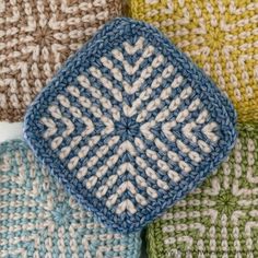 four crocheted squares are arranged in different colors