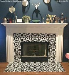 the fireplace is decorated with black and white tiles, deer heads on the wall above it