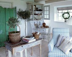 a living room filled with furniture and a potted plant on top of a table