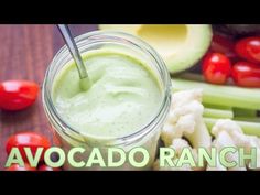 an avocado ranch smoothie in a mason jar surrounded by fresh fruit and vegetables