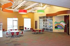 an empty school room with tables and chairs