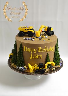 a birthday cake that is decorated to look like a tractor and some trees on it