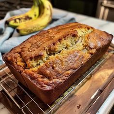 a loaf of banana bread sitting on top of a cooling rack