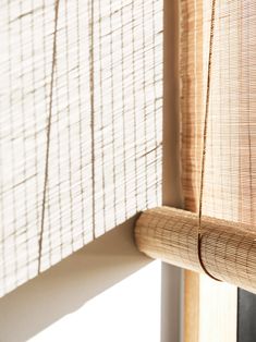 a bamboo curtain is hanging on the side of a window