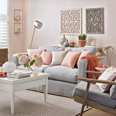 a living room filled with lots of furniture and flowers on top of a coffee table