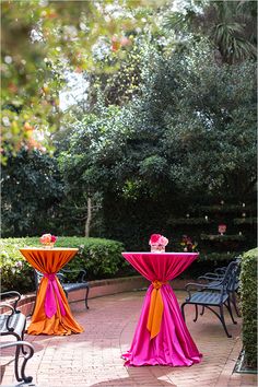 two tables covered in pink and orange cloths