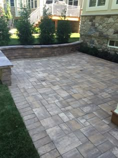 a brick patio in front of a house