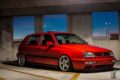 a red car parked in a parking garage