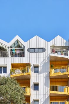 an apartment building with balconies and yellow balconies