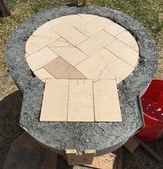 an outdoor fire pit made out of concrete blocks