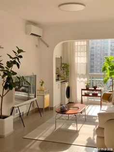 a living room filled with furniture and a flat screen tv sitting on top of a wooden table