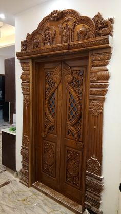 an ornate wooden door in the middle of a room