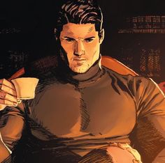 a man sitting in a chair holding a coffee cup and looking at the camera while wearing a star trek uniform