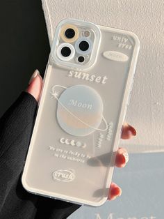 a woman holding up her phone case with the sun set moon on it in front of her