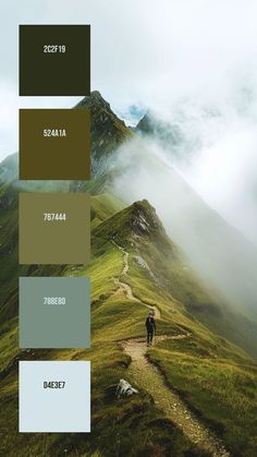 a person walking up a hill with mountains in the background