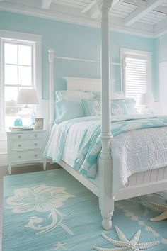 a white bed sitting in a bedroom on top of a blue rug