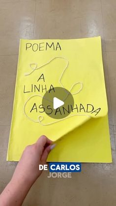 someone is writing on a piece of yellow paper with the words poema la lunana asasanha?