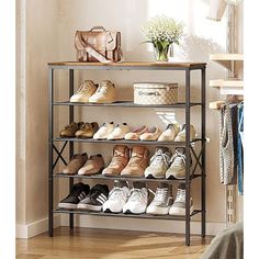 the shoe rack is holding many pairs of shoes