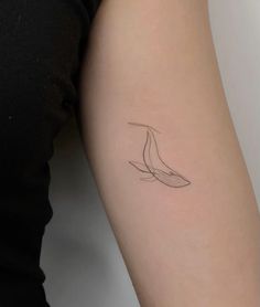 a woman's arm with a tattoo that has a line drawing of a bird on it