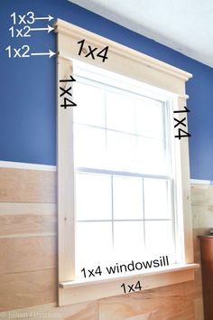 a window with measurements for the top and bottom half of it in front of a blue wall