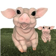 a pig and her baby sitting in the grass together, with one looking at the camera