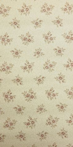 an old fashioned wallpaper with flowers and leaves on it's back drop down