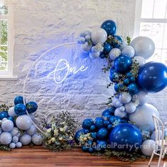 blue and white balloons are arranged in the shape of an arch