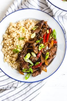 a white plate topped with beef and rice