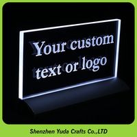 an illuminated sign with the words your custom text or logo on it in front of a green background