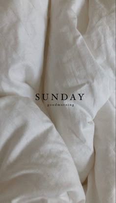 an unmade bed with white sheets and the words sunday written on it in black