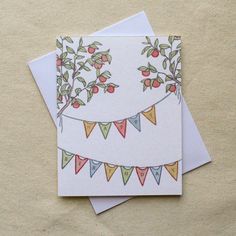 two cards with bunting flags on them sitting next to each other and one has an apple tree in the middle