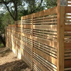 a wooden fence in the middle of a park