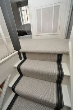 a set of stairs with black and white carpet