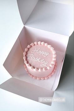 a pink birthday cake in a white box with the words happy birthday written on it