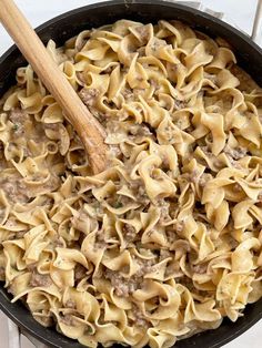 a skillet filled with pasta and meat