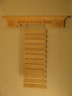 a wooden shelf that has some sort of item on it with the words martial artist's name written on it