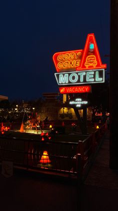 the motel sign is lit up at night