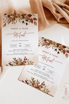 two wedding cards with leaves on them