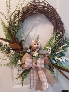 a wreath with an owl sitting on top of it