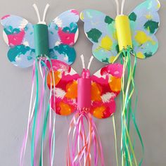 paper plate butterfly craft with streamers on the wings and colorful streamers attached to it