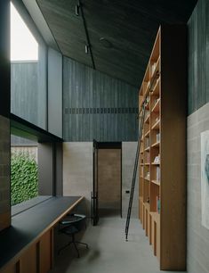 an empty room with bookshelves and desks