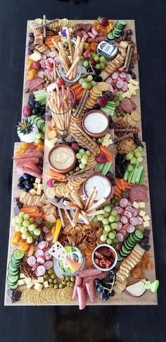 a table filled with lots of different types of food and snacks on top of it