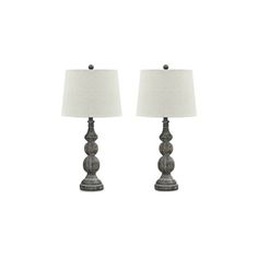 a pair of lamps sitting next to each other on a white surface with a light shade