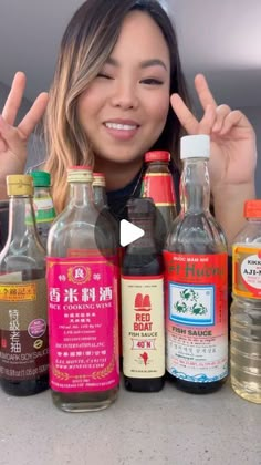 a woman standing in front of several bottles