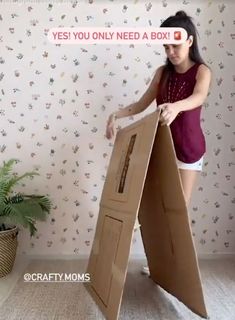 a woman is opening up a cardboard box