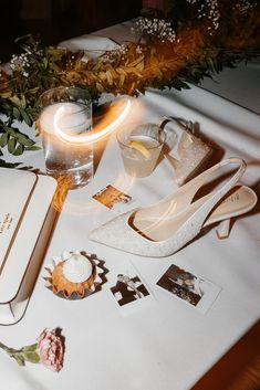 a table topped with white shoes and other items